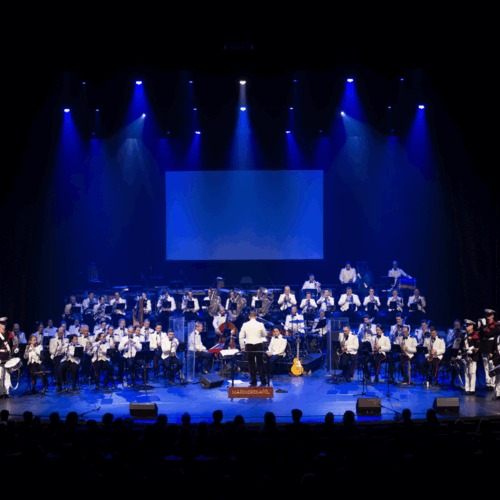 marinierskapel op het podium in blauwe spotlights